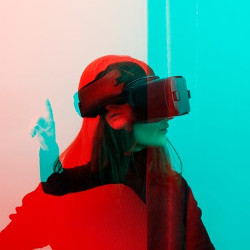 person looks and reaches while wearing VR goggles 