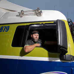A trucker wears a headband that monitors his biometric data for fatigue.