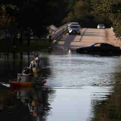 A Houston, TX, resident wades through a flooded road on Sept. 6, 2017.