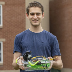 Binghamton University junior Jacob Goodman holding his ventilator prototype