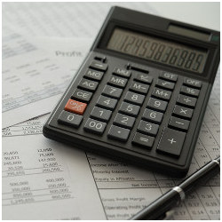 calculator, pen, and balance sheet