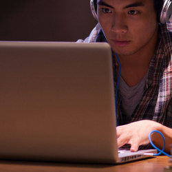 student at laptop computer