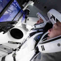 Astronauts Bob Behnken and Doug Hurley train on the new controls.