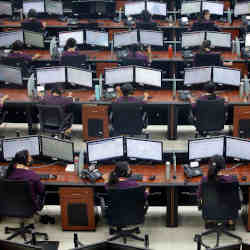 Employees wear protective masks inside a call center run by Uttar Pradesh state police.