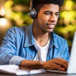 A young man taking an online course. 