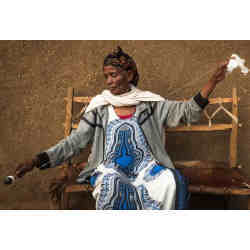 A woman in Ethiopia spins cotton into thread. 