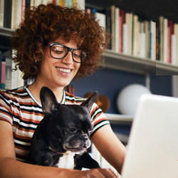 female worker with dog at computer