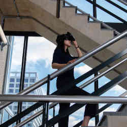 A study participant navigates a staircase guided by a virtual reality headset.