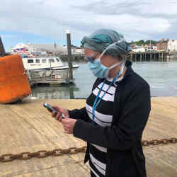 A National Health Service worker testing a contact-tracing app.