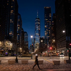 girl in NYC at night with One World Trade in background