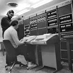 Dennis Ritchie, standing next to a seated Ken Thompson, in this 1973 photo.