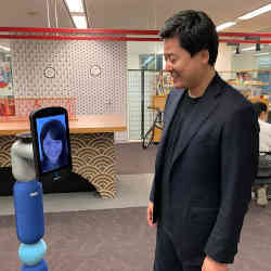 Avatarin chair Akira Fukabori chats with a colleague via his companys newme robot.