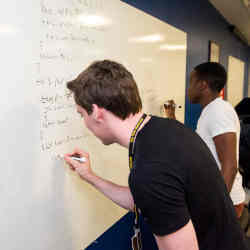 Coding on a whiteboard. 