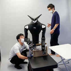 Telexistence staffers work on the Model T robot. 