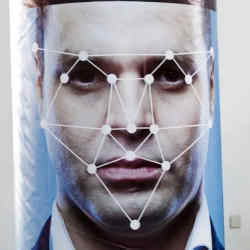 Using a facial recognition system on a man. 