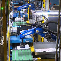 Robotic arms sort packages at the FedEx Express World Hub in Memphis, TN.