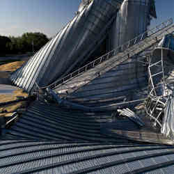 Grain bins crumpled by severe windstorms in Luther, IA.