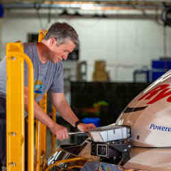 An Ike Robotics technician adjusts a sensor on the cab of a Ryder truck.