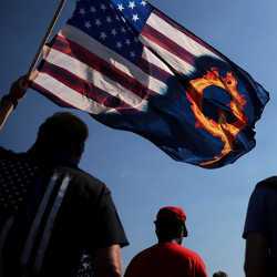 QAnon demonstrator with U.S.-QAnon flag