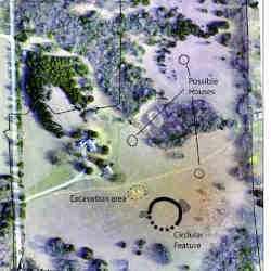Newly discovered earthwork and a few possible houses are marked on an aerial image of the site.