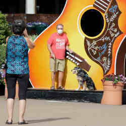 Tourists snap a photo in Nashville, TN, a city using artificial intelligence software to track short-term vacation rentals.