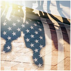 shadow of workers in street on U.S. flag