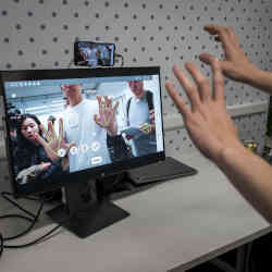 People trying out hand-recognition technology.