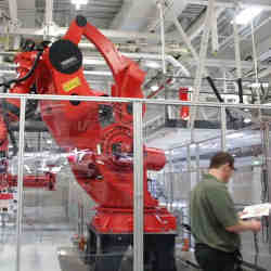 A worker and a robot in Tesla's factory in Fremont, CA.