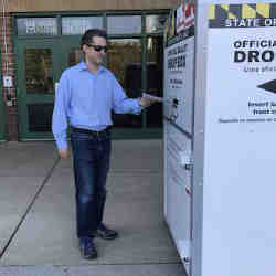 Albanese drops off his mail-in ballot. 