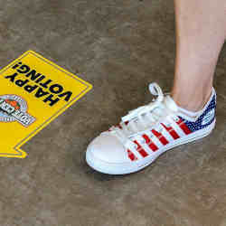 A voter wears patriotic sneakers.