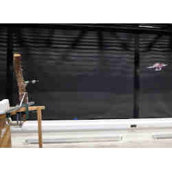 The drone (right) shoots a dart that sticks in its target (left). 