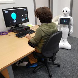 humanoid robot aside study participant at computer