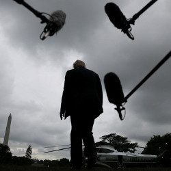 President Trump walking to a Marine One helicopter