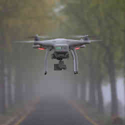 An aerial drone patrols a forest.