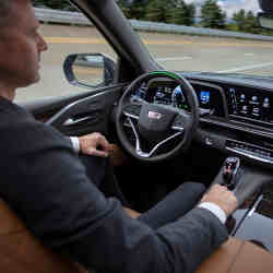 A driver tests a 2021 Cadillac Escalade SUV with Super Cruise hands-free driving assistance.