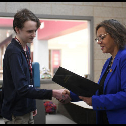 David Love accepts letter of recognition from U.S. Rep. Robin Kelly