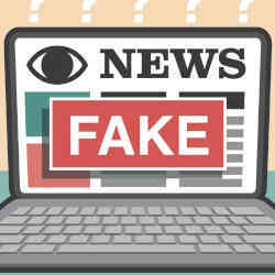 A news item labeled "fake" on a laptop.