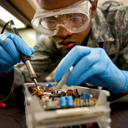 STEM student soldering a circuit board