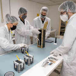 Carnegie Mellon University researchers prepart CubeSats for space. 