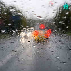 Heavy rain on an auto windshield.