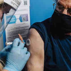 A man receiving a vaccination injection at a Walmart in Maine. 