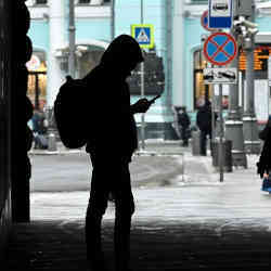 A young person in Russia checks their phone.