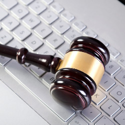 judge's gavel on white computer keyboard