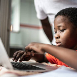 boy using laptop computer