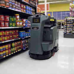 A robot monitors inventory on a grocery's shelves. 