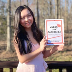 Danielle Park holding a copy of 'Under One Condition'