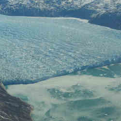 Satellite image of the calving front of a crevassed glacier in southwest Greenland.