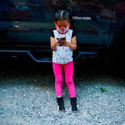 A child accessing an app with a smartphone.