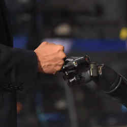 President Barak Obama bumped fists with bumped fists with Nathan Copeland, who was using a previous version of the robotic arm during a tour of innovation projects at the White House Frontiers Conference at the University of Pittsburgh in 2016. 