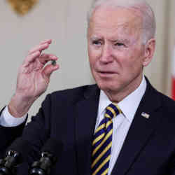 U.S. President Joe Biden holds a semiconductor while discussing chip subsidies earlier this year. 